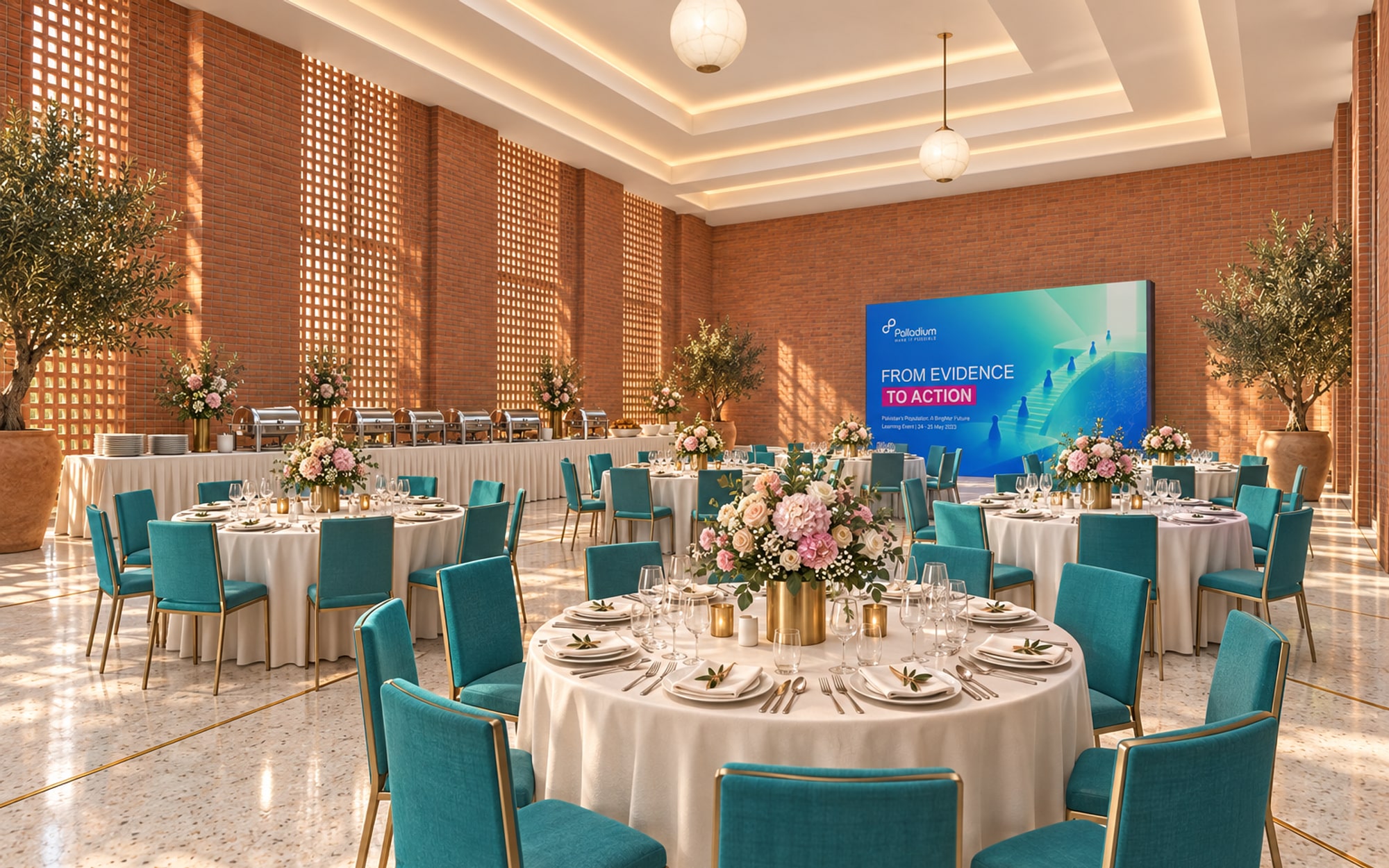 A dining room with round tables in ivory linen, ten chairs with teal backs at each, flowers at the centre of every table and a buffet line along the far wall