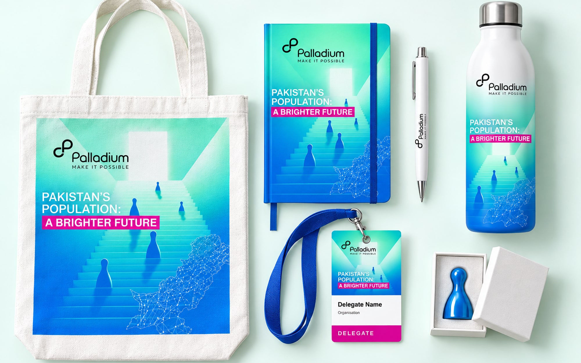 A delegate kit laid out from above: a canvas tote, a notebook, a pen, a lanyard and badge, a bottle and a small blue pawn in a box, all carrying the key visual