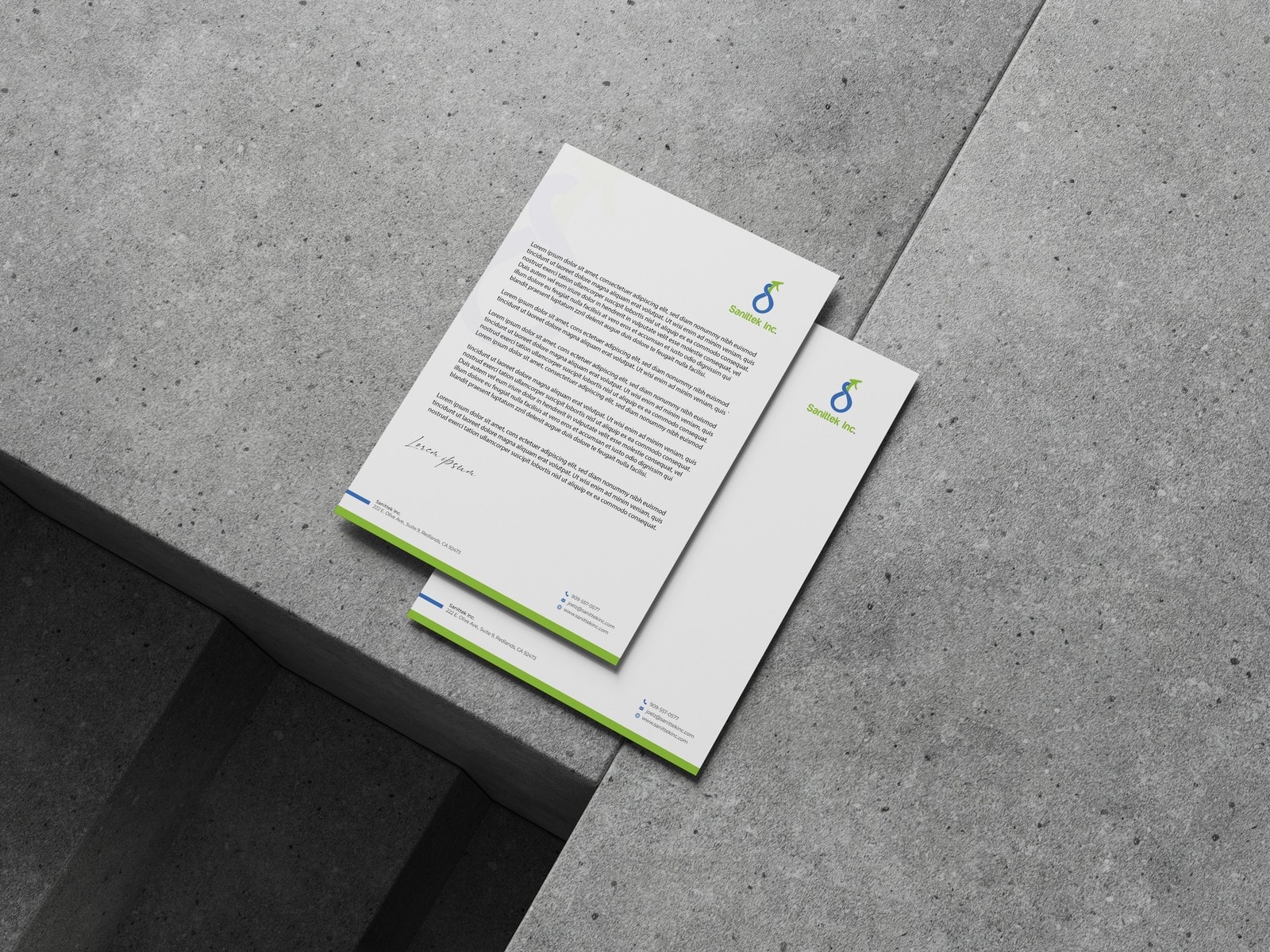 Two Sanittek letterheads overlapping on a grey concrete step, lit hard from one side.